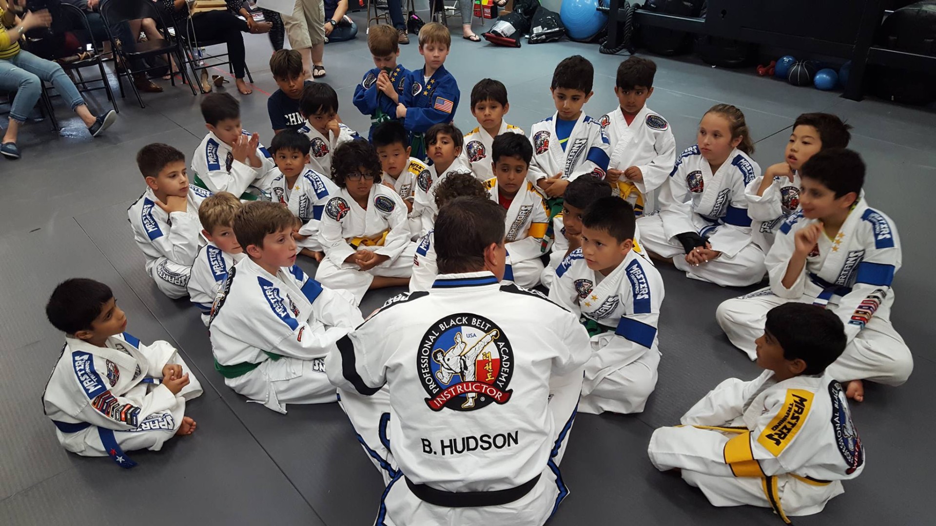 Students gathered around Master Buddy Hudson during class